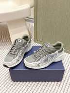 Grey lace-up sneakers with white midsoles and side logo detailing on both shoes