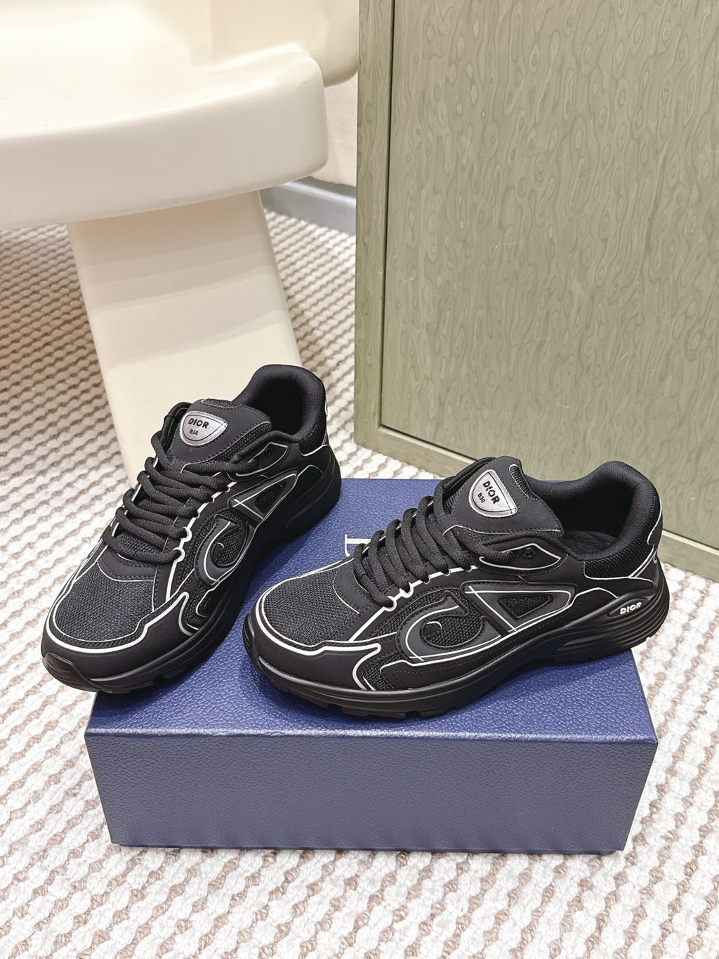 Black lace-up sneakers with chunky sole and white signature-style side details
