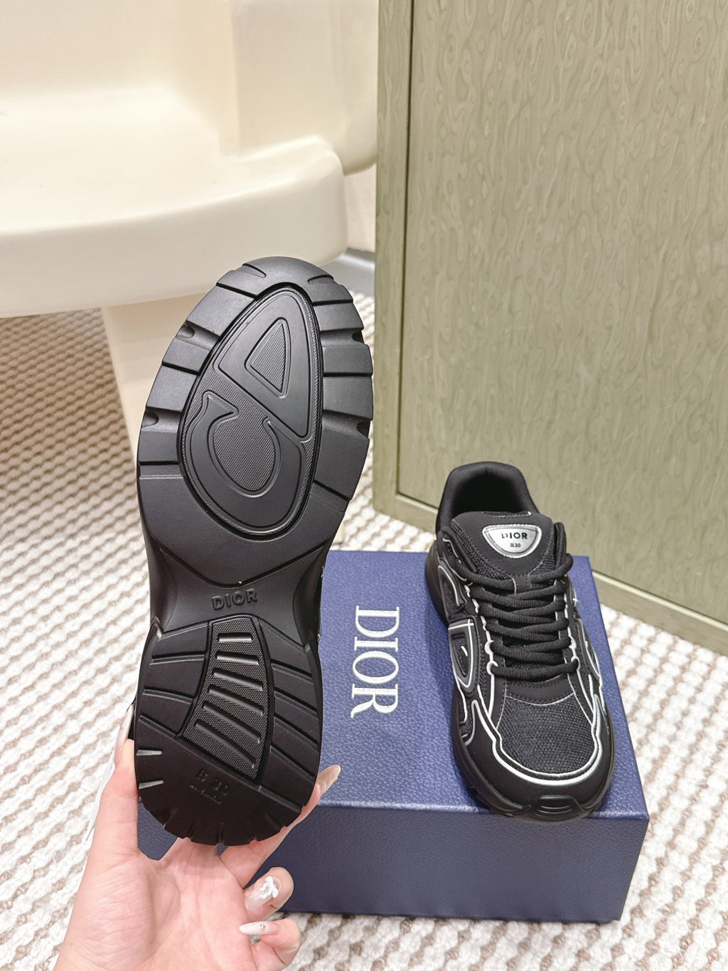 Black sneaker outsole view and lace-up side with Dior patch