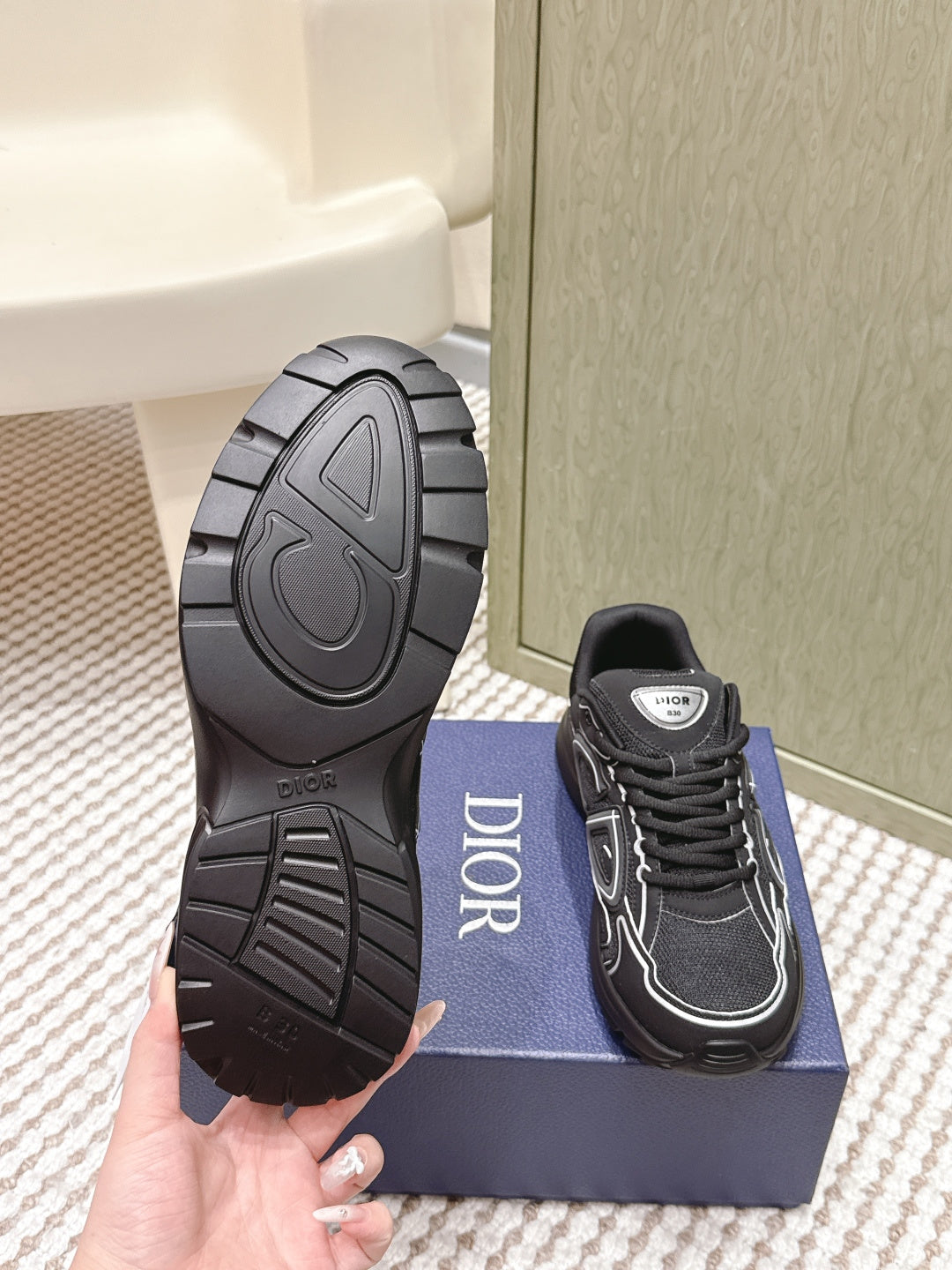 Black sneaker outsole view and lace-up side with Dior patch