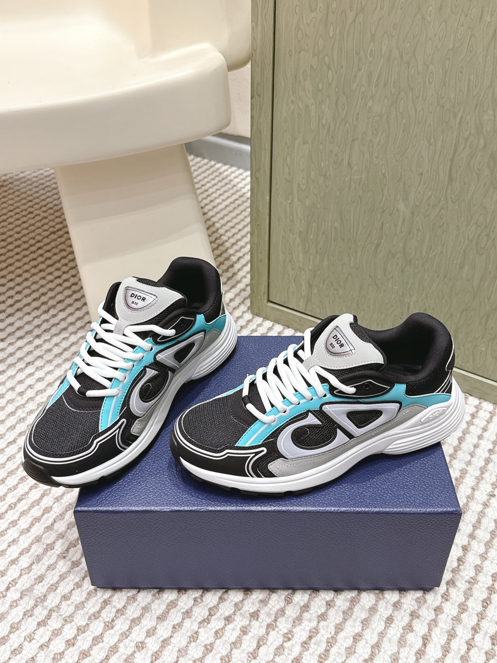 Dior unisex sneakers pair, black upper with turquoise trim and white laces