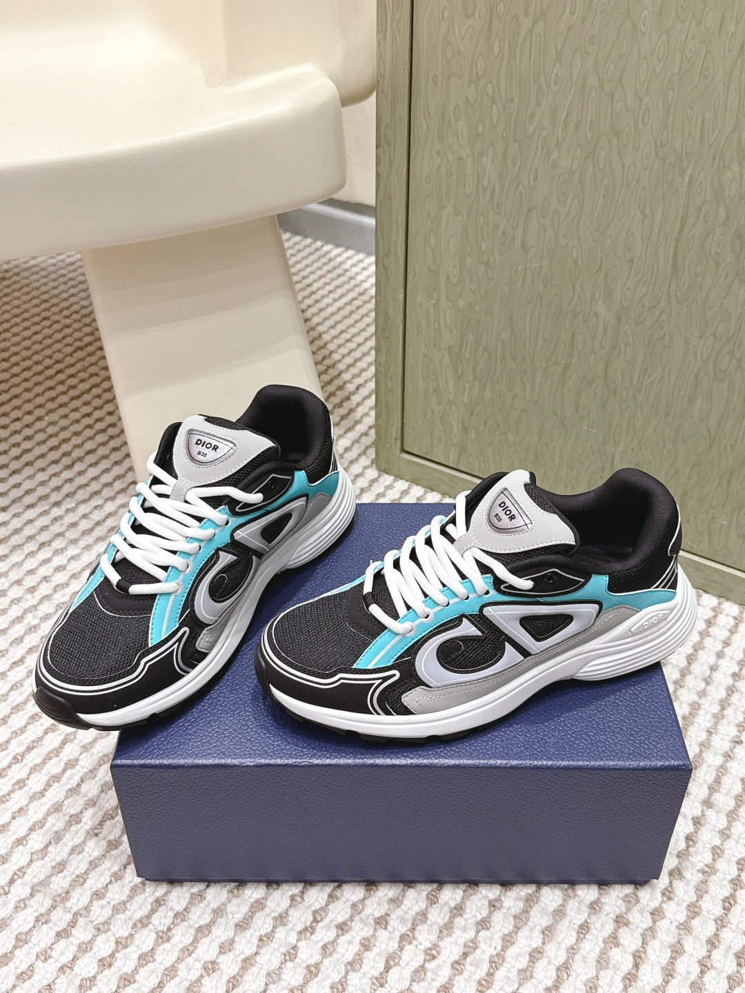 Dior unisex sneakers pair, black upper with turquoise trim and white laces