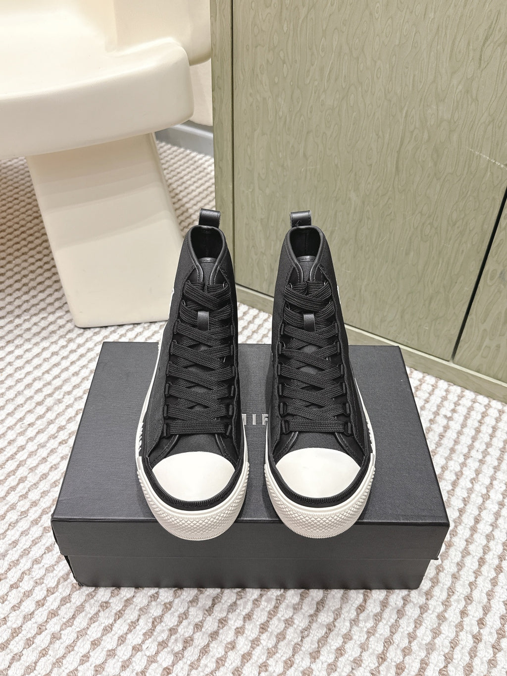Amiri black high-top sneakers with lace-up design and white rubber toe caps
