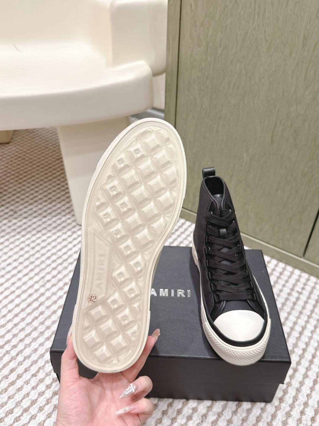 Amiri black high-top sneakers with visible tread outsole and lace-up front
