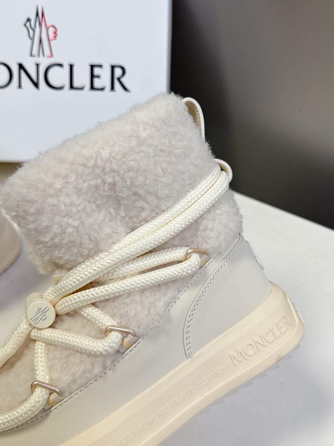 Cream sherpa-collar lace-up sneakers with white laces and textured side panels