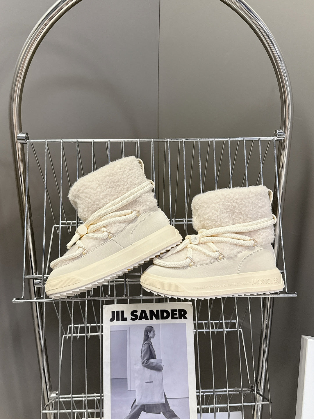 Cream high-top lace-up shoes with sherpa lining and white rope laces, side view