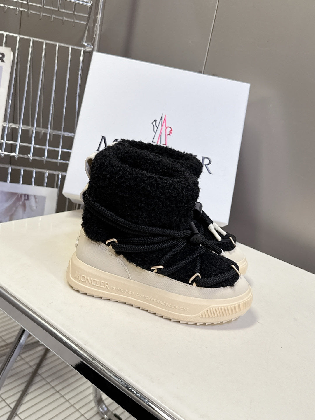 Moncler luxury shoes: black sherpa lined boots with laces and cream platform sole