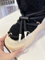 Moncler luxury shoes: black lace-up boot detail with metal lace tips and cream sole