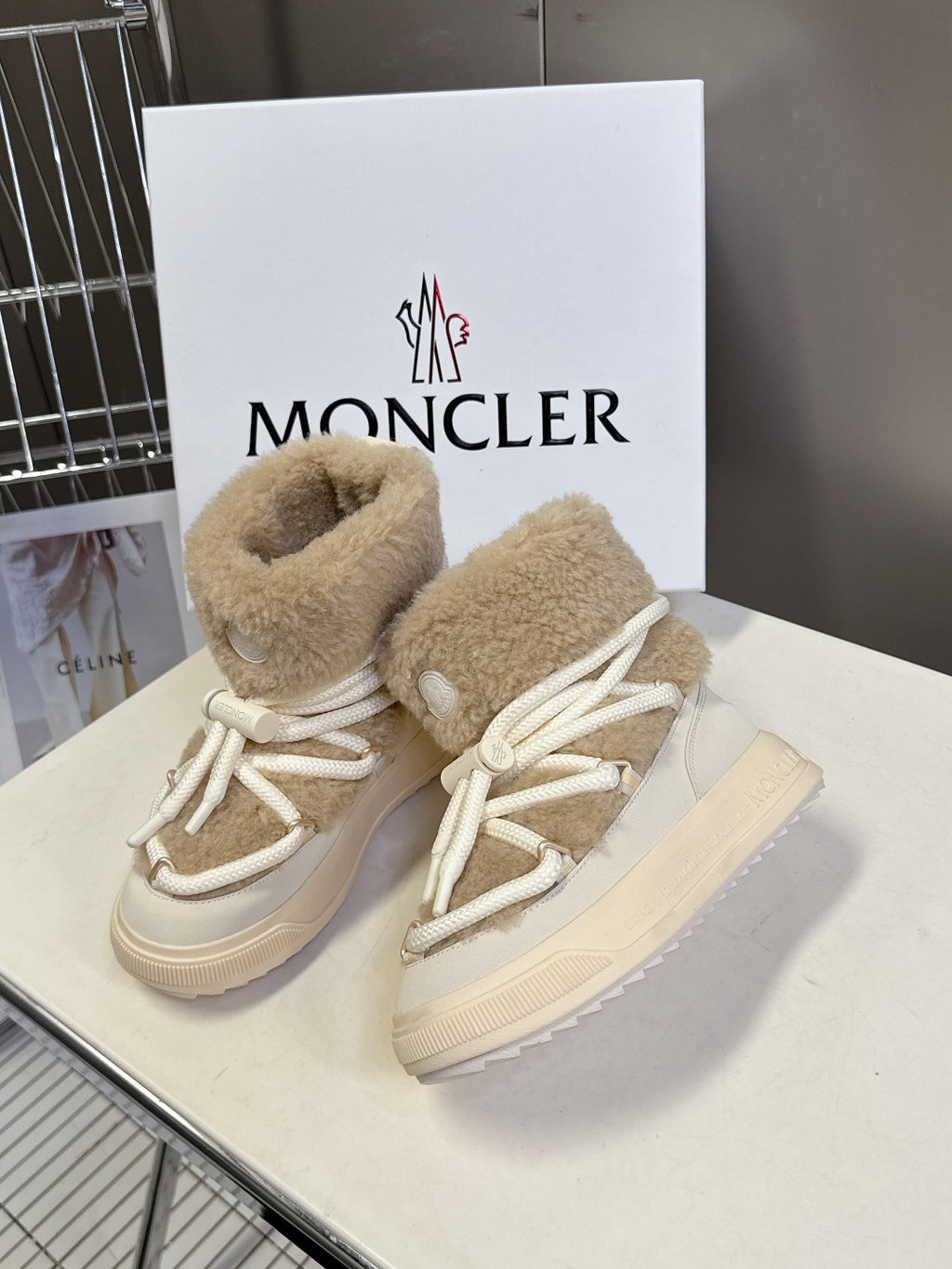Beige shearling high-top boots with white laces and side logo patch