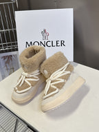 Beige shearling high-top boots with white laces and side logo patch
