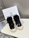 Moncler luxury shoes: black sherpa booties with black laces and cream soles, pair