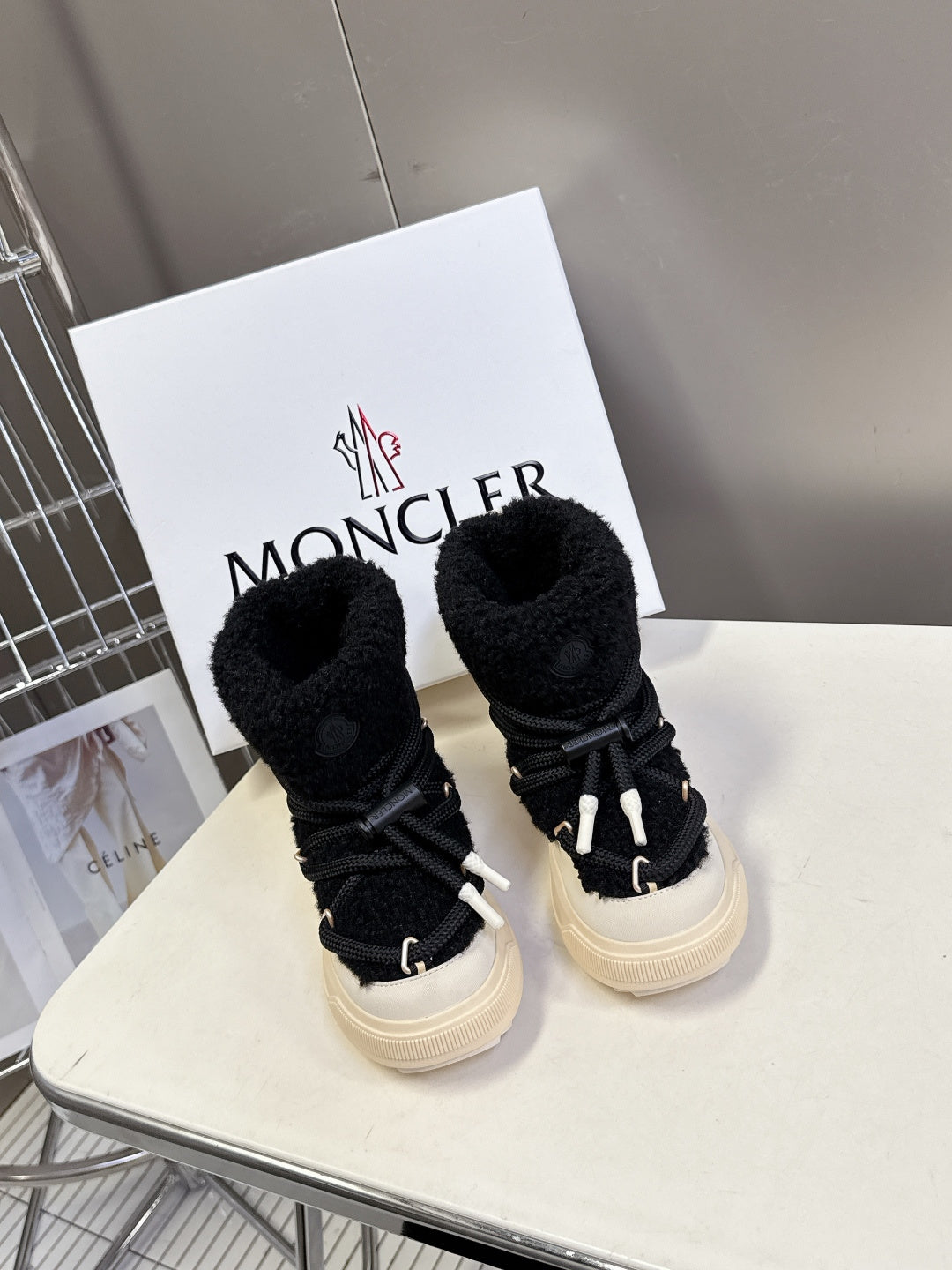 Moncler luxury shoes: black sherpa booties with black laces and cream soles, pair