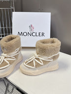 Pair of beige shearling lace-up boots with front logo patch and white laces