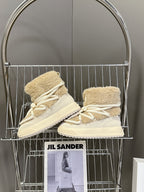 Beige shearling lace-up boots on rack, with white laces and side logo patch
