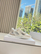 Unisex cream sneakers with lace-up design and cushioned midsole