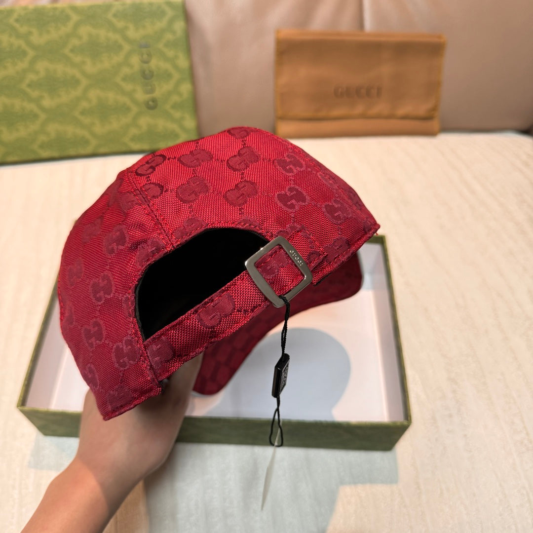 Back view of a red GG monogram baseball cap with adjustable strap and metal buckle.