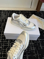 White and silver Dior low-top sneakers, front and side views on display