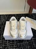 White Dior low-top sneakers with lace-up front and metallic side panels