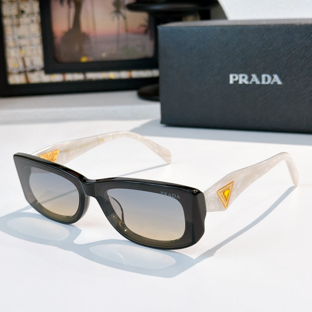 Sunglasses with black frame and dark lenses, gold triangle logo at temples.