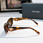 Tortoiseshell sunglasses with brown lenses and angular gold triangle logo at temple arms.