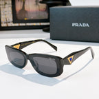 Sunglasses with dark green frame and gray lenses, gold triangle logo on temple arms.