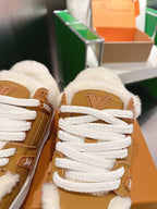Unisex tan sneakers close-up: fluffy fur collar and white lace with LV logo patch