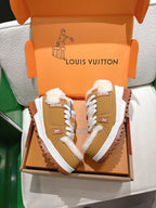 Unisex tan sneakers with white laces and fluffy fur lining in an open gift box