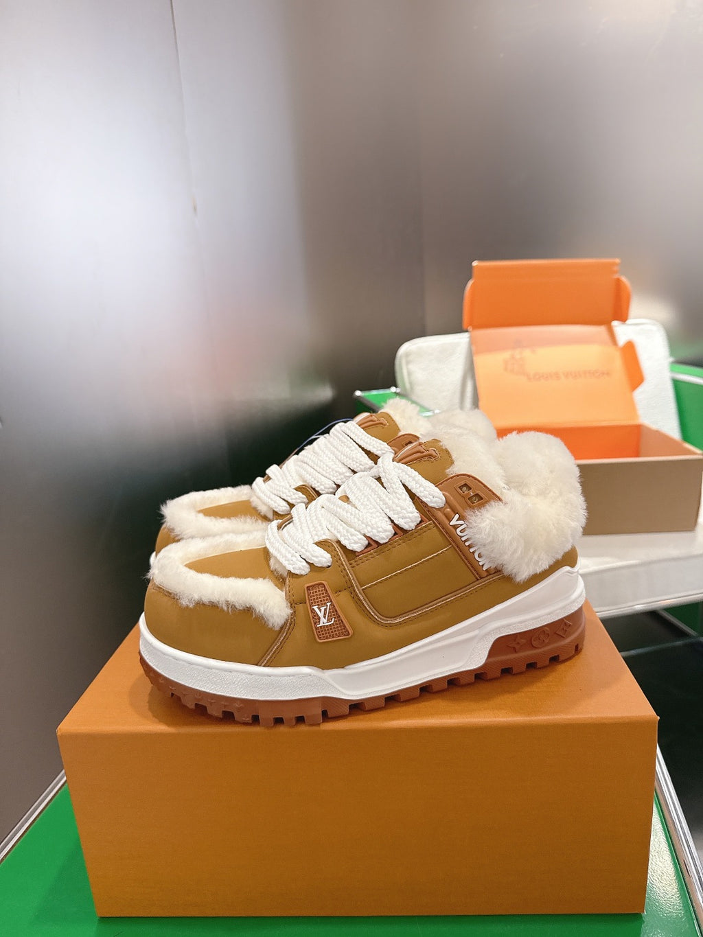 Unisex tan high-top sneakers with white laces, fur trim, and thick rubber sole