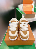 Unisex tan sneakers with white laces, white sole, and fluffy fur trim