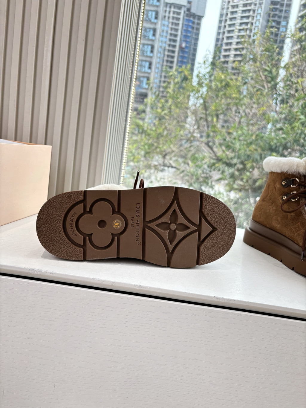 Louis Vuitton ankle boot sole, brown tread with quatrefoil-pattern detail.