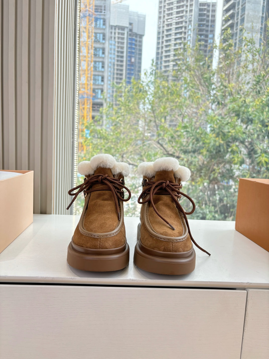 Louis Vuitton lace-up ankle boots with shearling trim, brown monogram canvas.