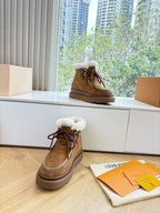 Louis Vuitton lace-up ankle boots, brown monogram with white shearling top and laces.