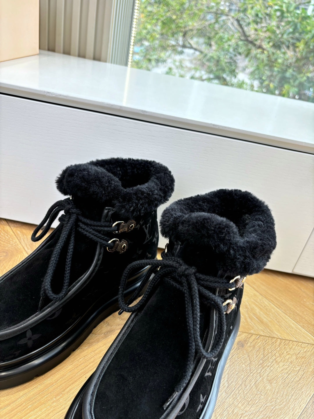Unisex Louis Vuitton black monogram boots with faux fur cuff and lace-up laces