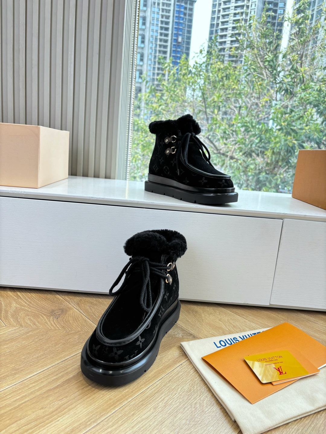 Unisex Louis Vuitton black monogram ankle boots with faux fur lining and lace-up ties