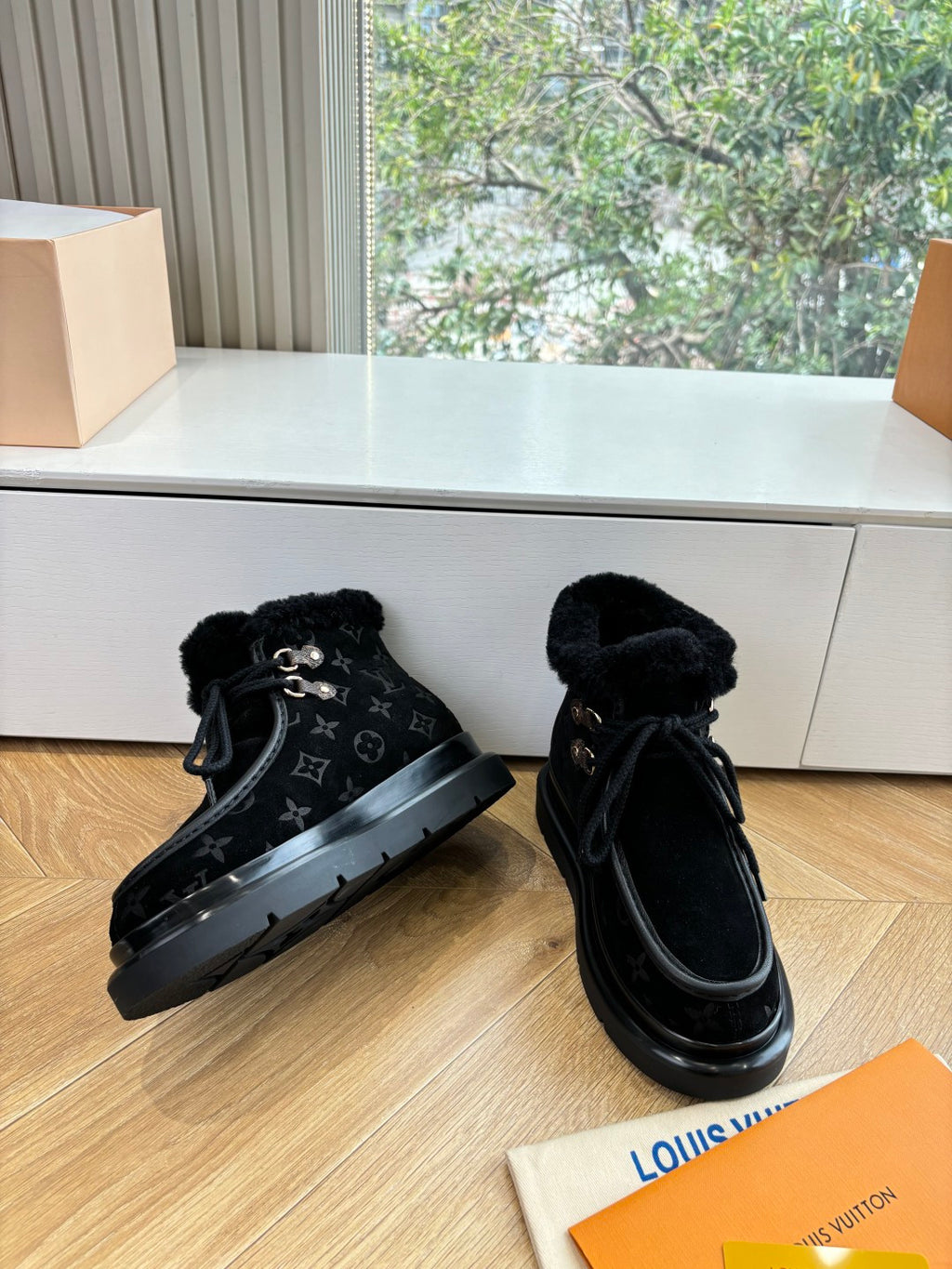 Unisex Louis Vuitton black monogram lace-up boots with faux fur cuff and rubber sole