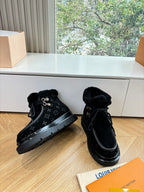 Unisex Louis Vuitton black monogram lace-up boots with faux fur cuff and rubber sole