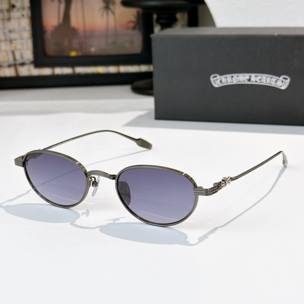 Round sunglasses with dark lenses and dark metal frame, thin bridge details.