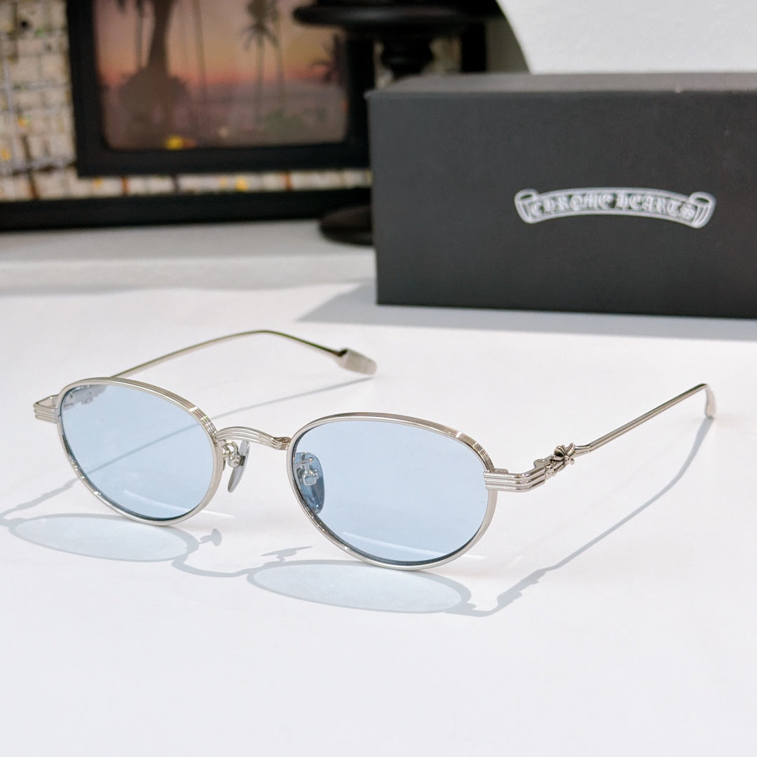 Round sunglasses with light blue lenses and silver metal frame, thin arms.
