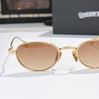 Gold round sunglasses with tinted lenses and curved temple hinges, side view.