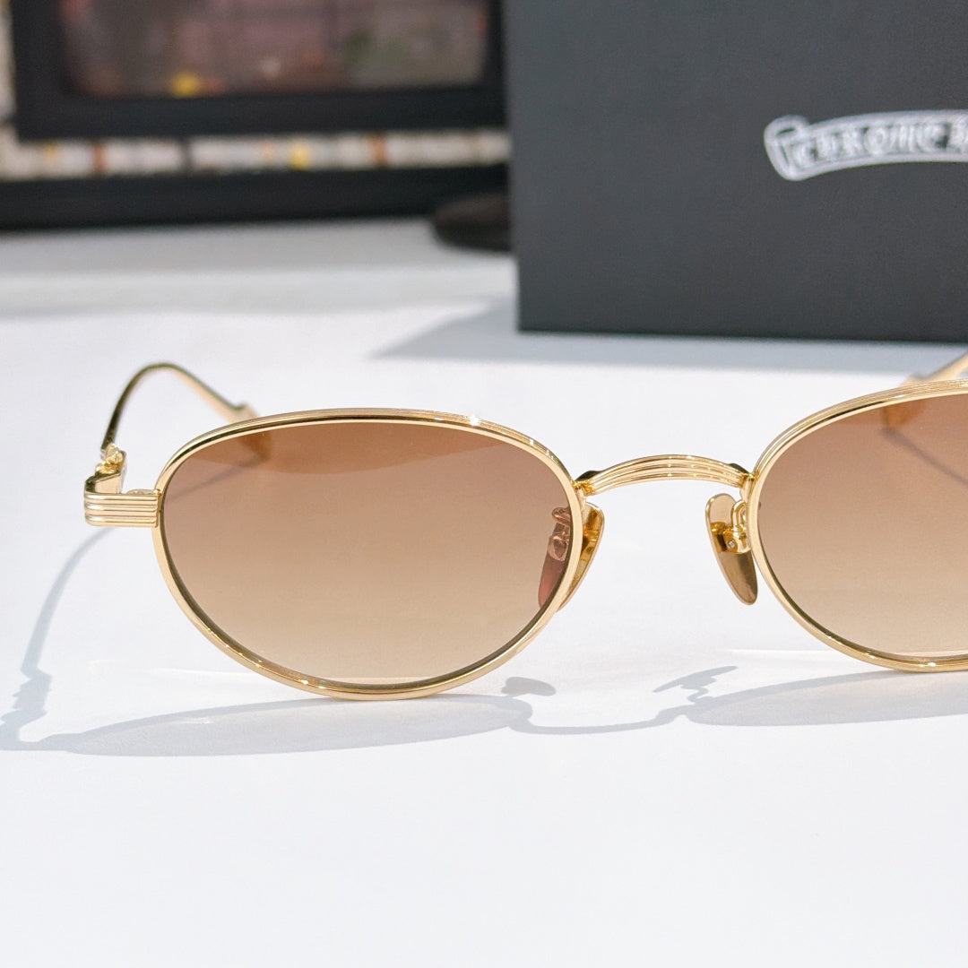Gold round sunglasses with tinted lenses and curved temple hinges, side view.