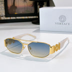 Gold sunglasses with blue lenses and decorative temple logo detail