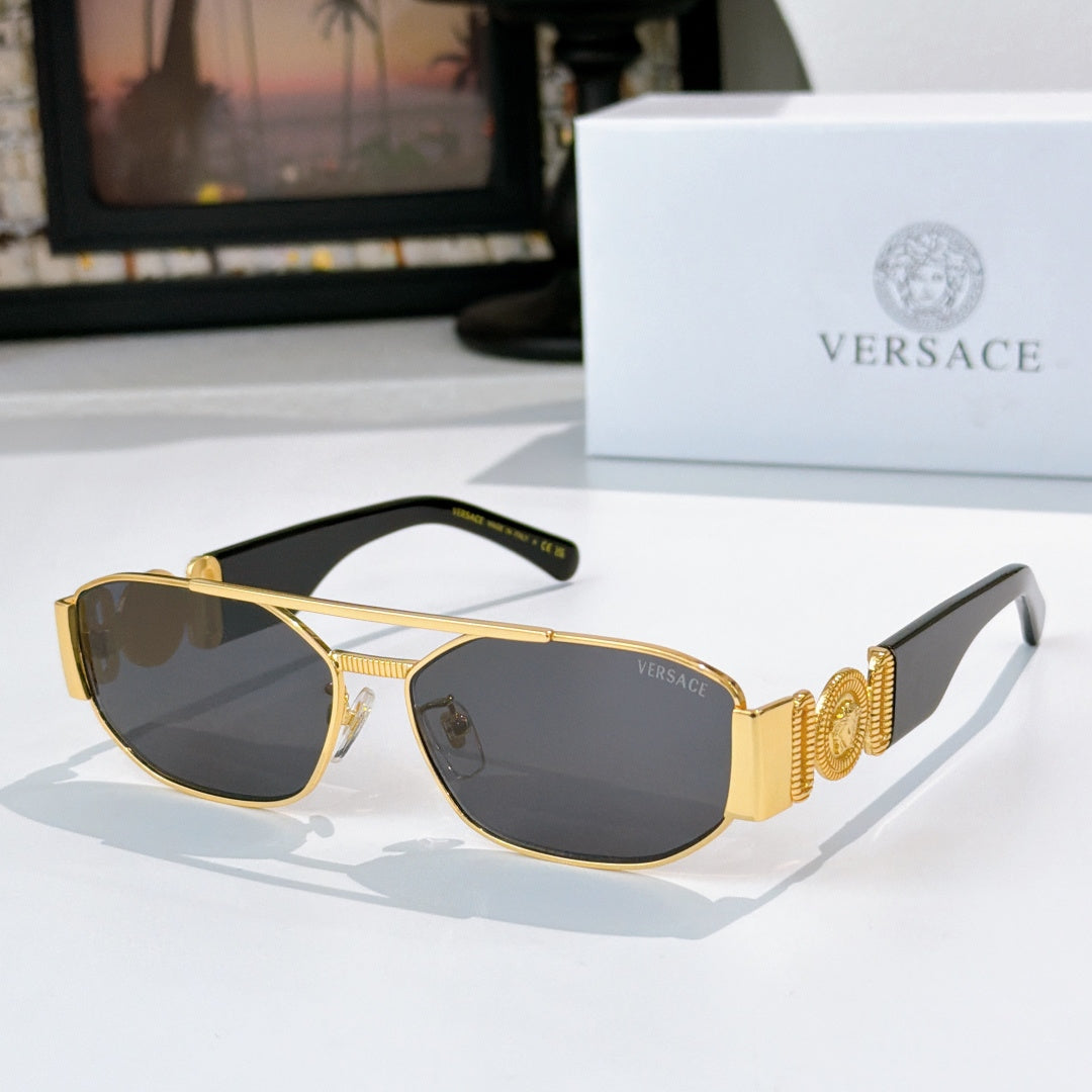 Versace sunglasses with gold frame and dark lenses, patterned temple band detail