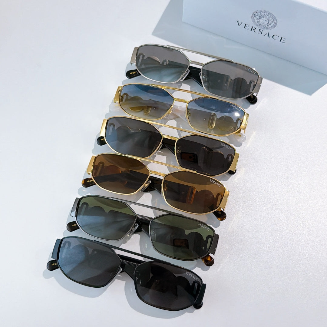 Assorted sunglasses with mixed frames and tinted lenses, stacked on display