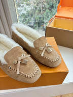 Unisex taupe suede moccasins with white shearling lining and tassel detail