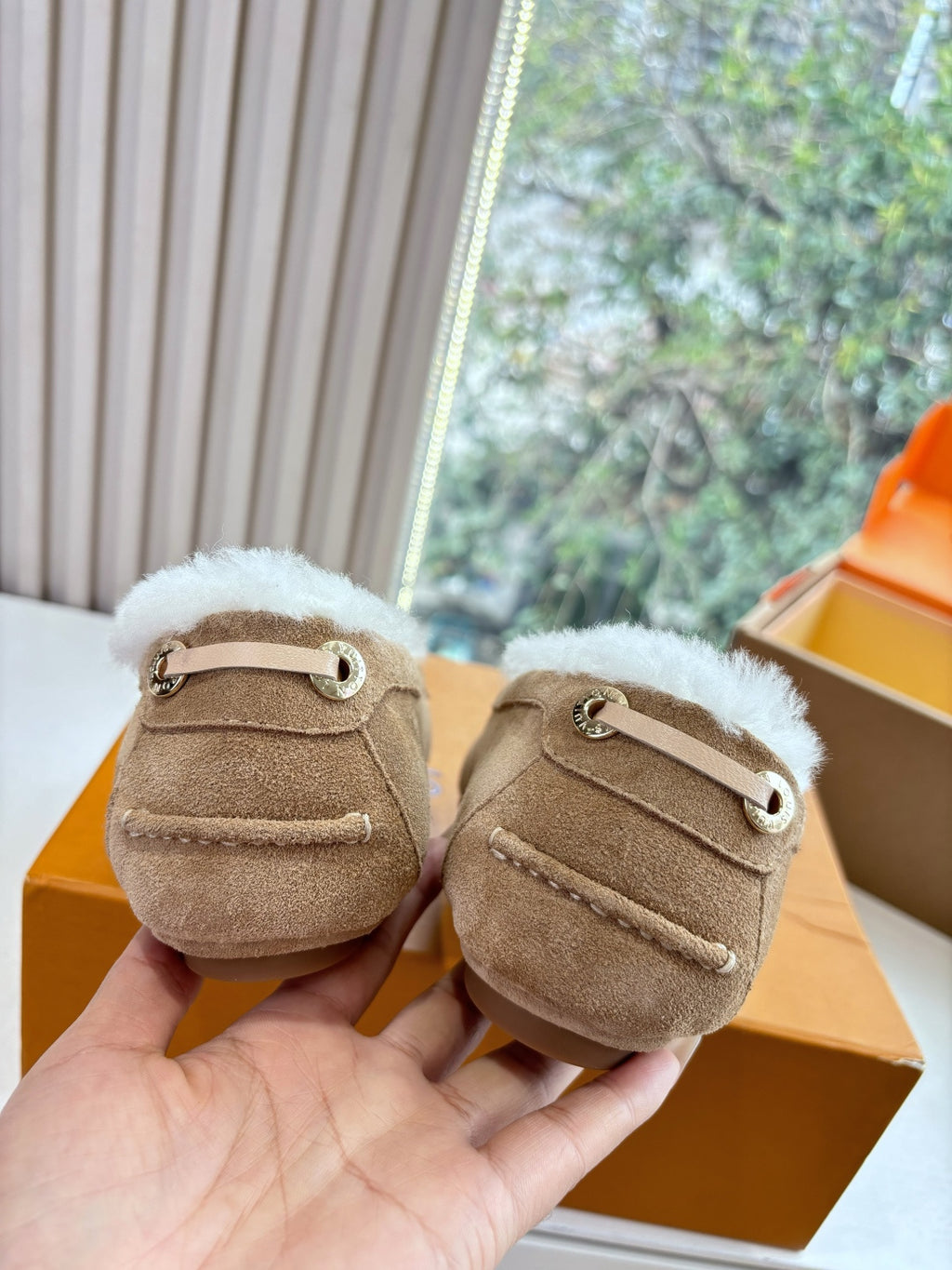 Unisex taupe suede loafers with white shearling lining and strap with eyelet