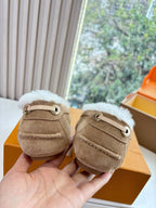Unisex taupe suede loafers with white shearling lining and strap with eyelet