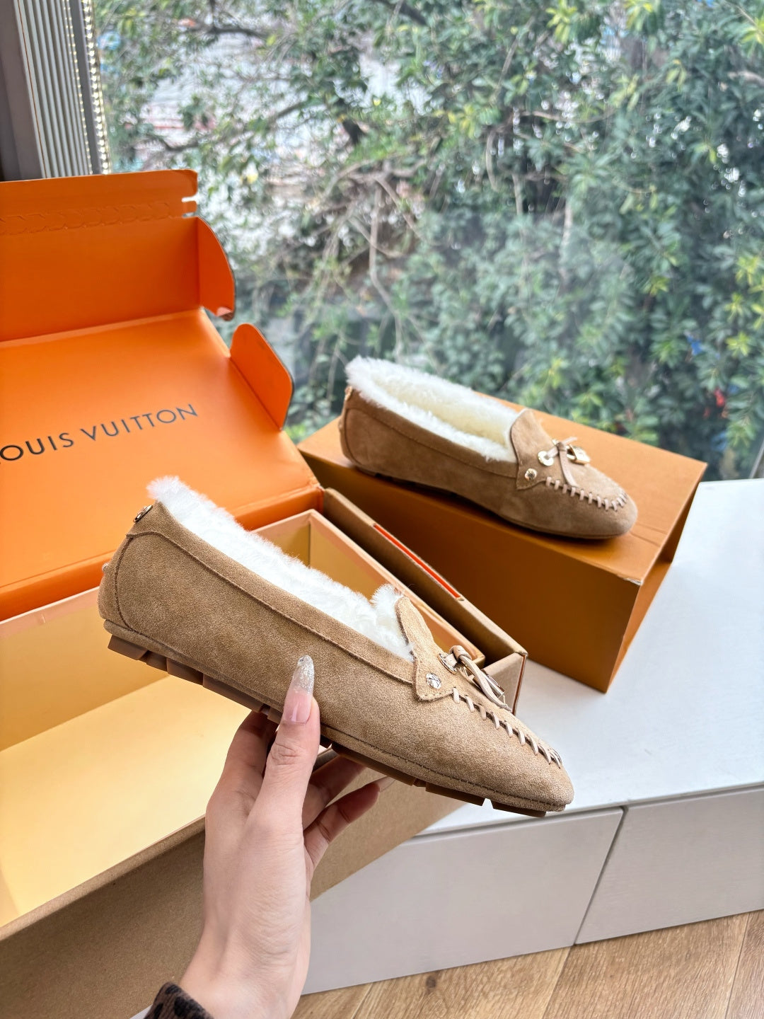 Unisex taupe suede loafers with white shearling lining and tassel detail