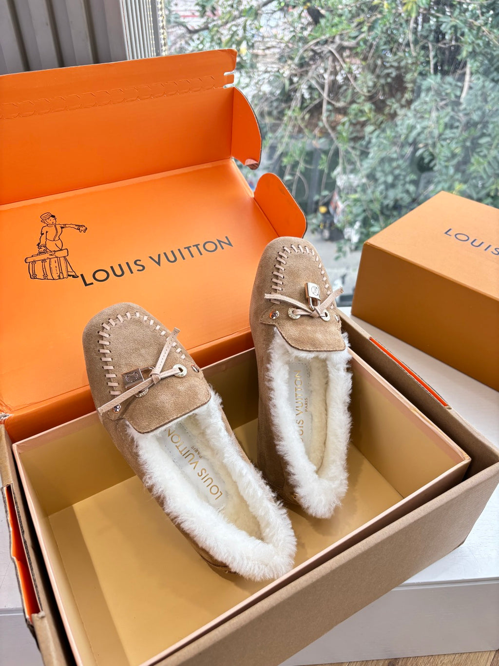 Unisex taupe suede moccasin loafers with white shearling lining and tassels