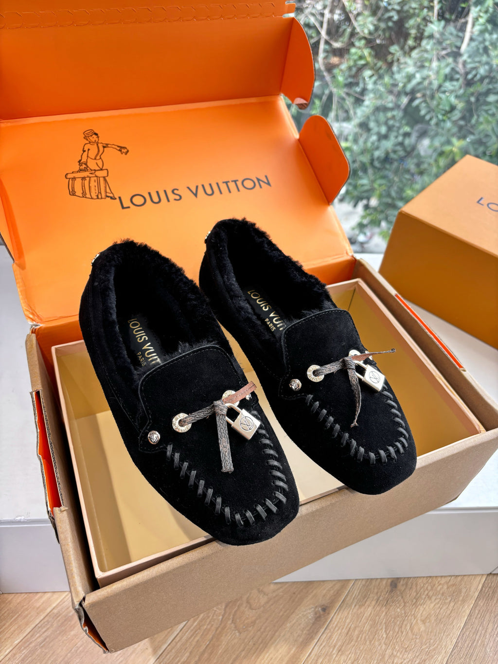 Black suede loafers with silver rope laces and LV charm detail