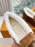 Brown suede loafer with cream shearling lining, showing branded insole text